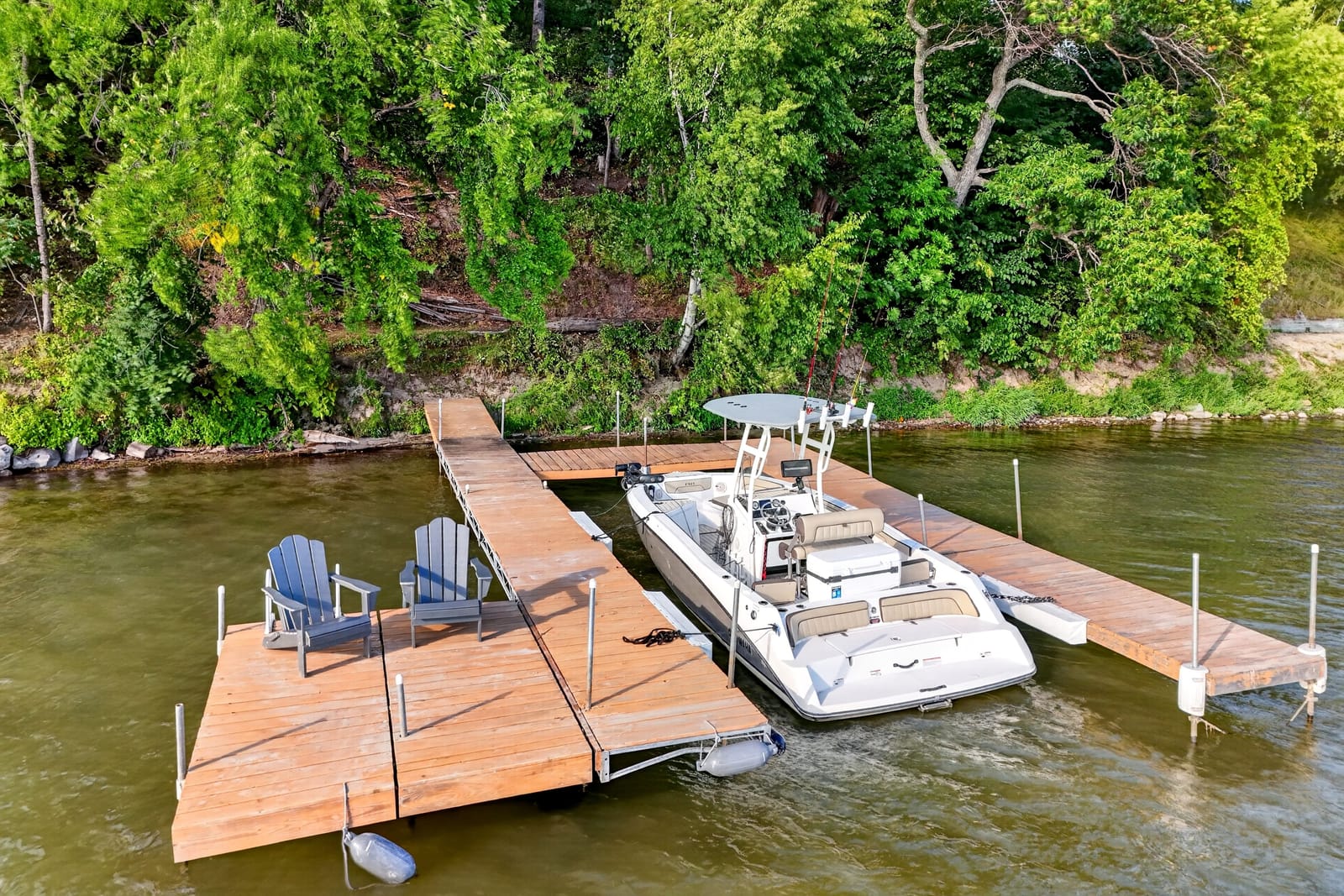 The private dock with the boat lift and chairs at the end.