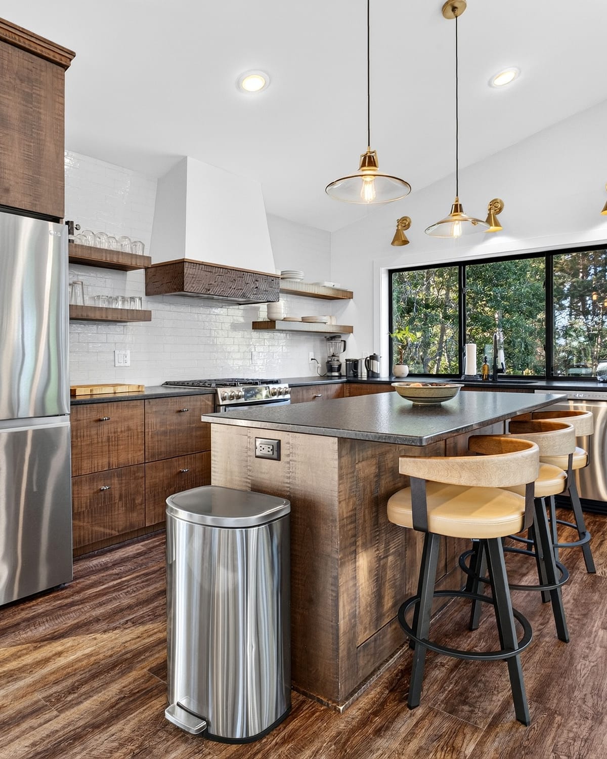The kitchen: dark cabinetry and black stone counters.